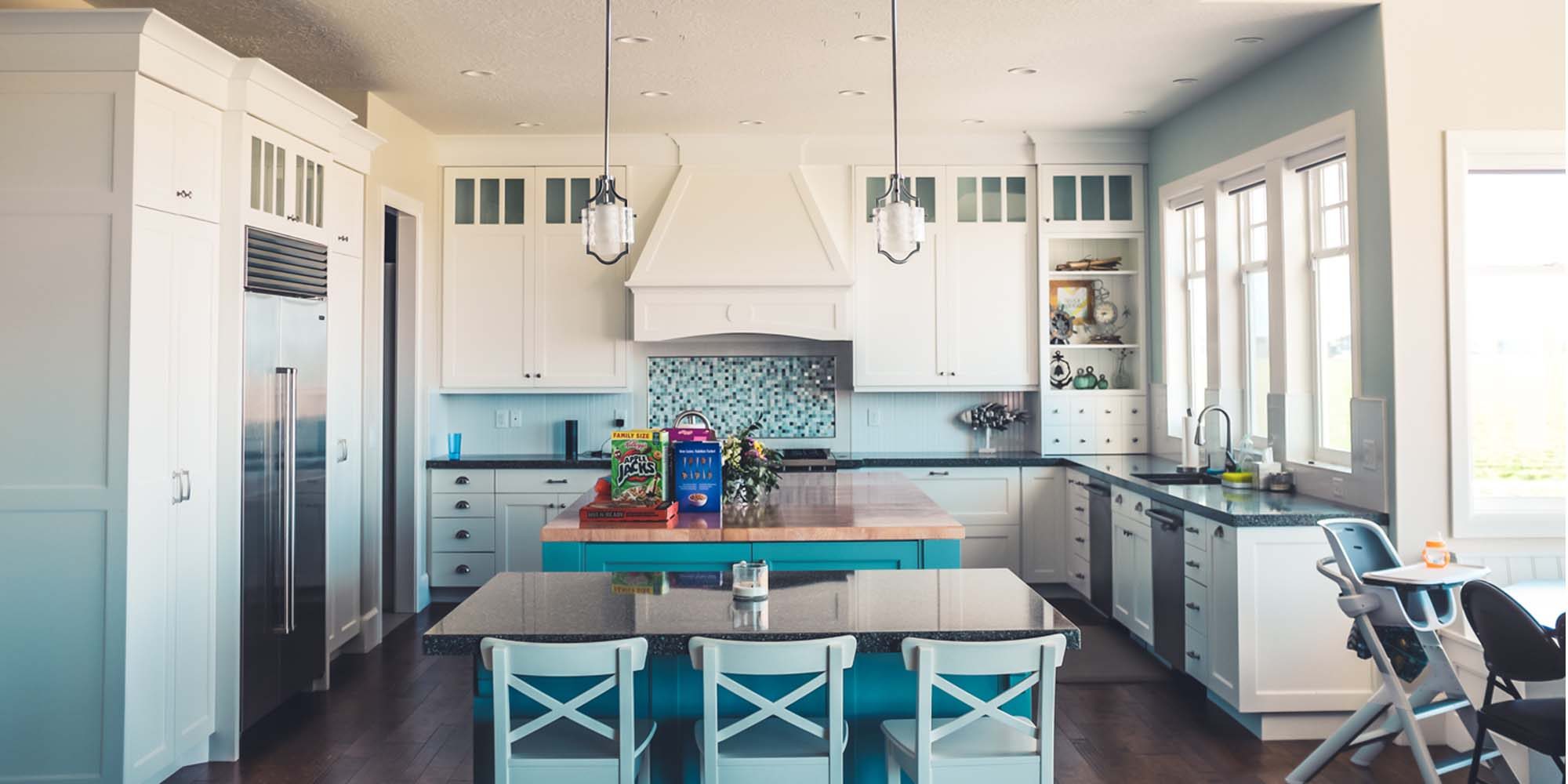 A white kitchen with turquoise accents.